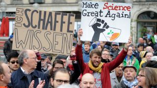Teilnehmer tragen beim "March for Science" durch die Münchner Innenstadt Schilder mit den Aufschriften "Make Science great again!" und "Ich schaffe Wissen!".