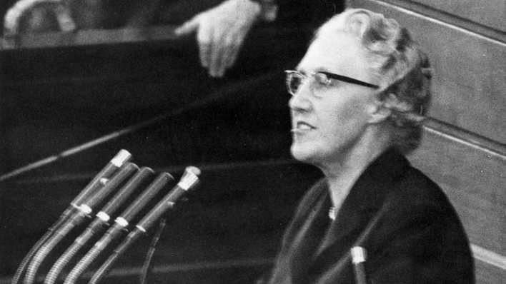 Die CSU-Abgeordnete Maria Probst am Rednerpult während einer Sitzung des Deutschen Bundestages in Bonn am 22.10.1959. Im Hintergrund Bundeskanzler Konrad Adenauer (CDU).