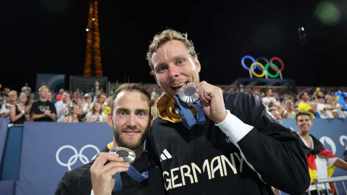 Nils Ehlers (r) und Clemens Wickler jubeln bei der Siegerehrung mit ihrer Silbermedaille.